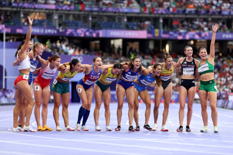 Women athletes standing together following running event at Paris Olympics