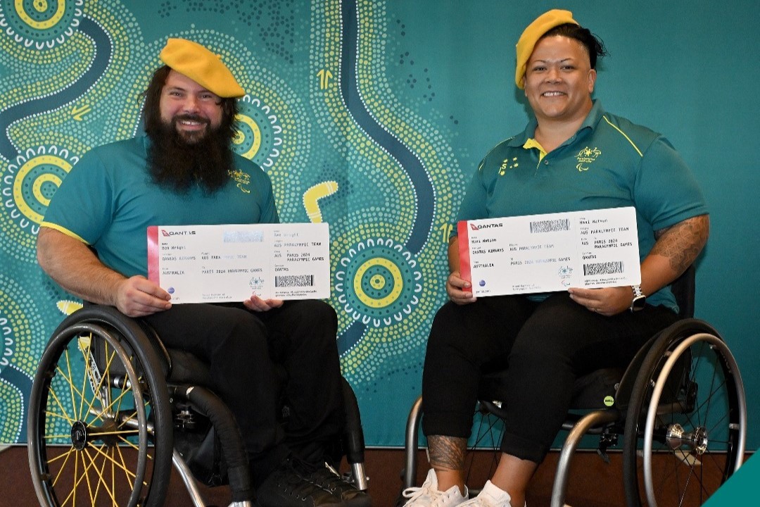 Para powerlifting champions Hani Watson and Ben Wright holding their tickets to Paris.